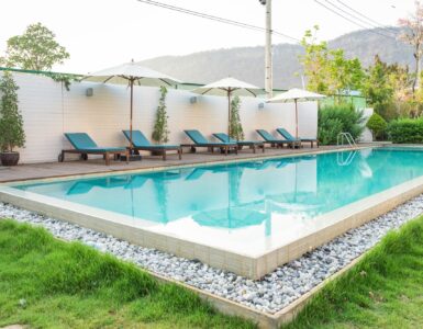 Swimming pool blue sunbed white umbrella in garden at prairie hills resort