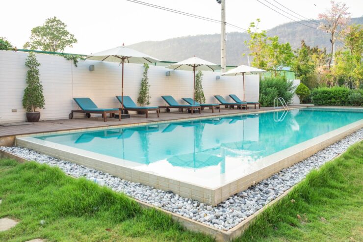 Swimming pool blue sunbed white umbrella in garden at prairie hills resort