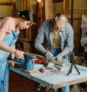 Man and woman doing refurbishment of furniture