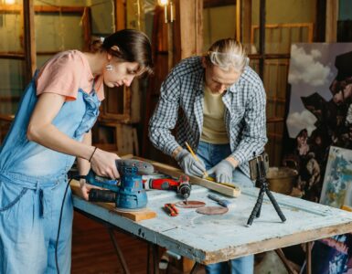 Man and woman doing refurbishment of furniture