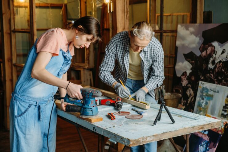 Man and woman doing refurbishment of furniture