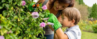 Mom and son taking care of plants in family garden